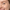 Close-up of a smiling woman with natural expression lines around her eye